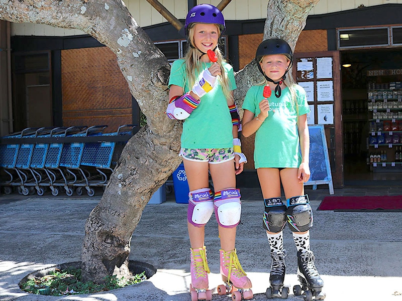 Girls on Skates in front of Hoku Foods eating popsicles